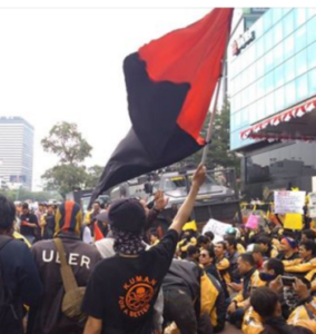 Kuman member with red and black flag