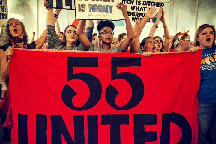 West Virginia teachers behind banner with "55 United"