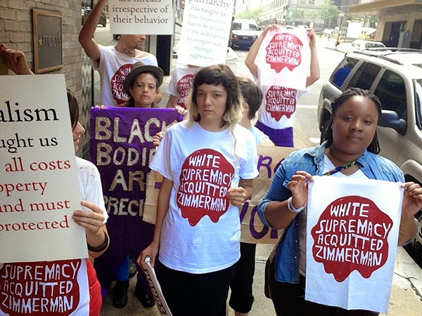 Image of women protesters holding signs "White Supremacy Acquitted Zimmerman"