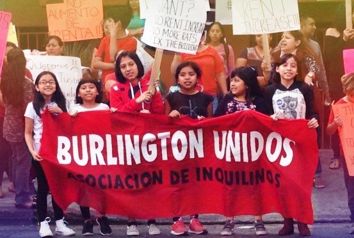 Children's holding banner "Burlington Unidos" as part of a renter protest in Los Angeles.