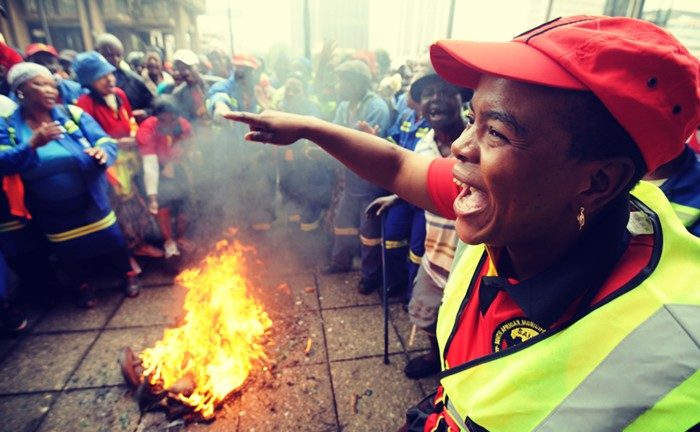 Trash workers affiliated to the South African Municipal Workers Union protest outside the City of Johannesburg.