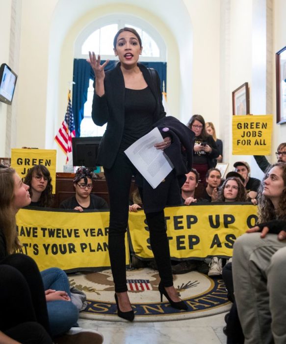 Photo of Ocasio-Cortez speaking to climate activists occupying the office of Nancy Pelosi.