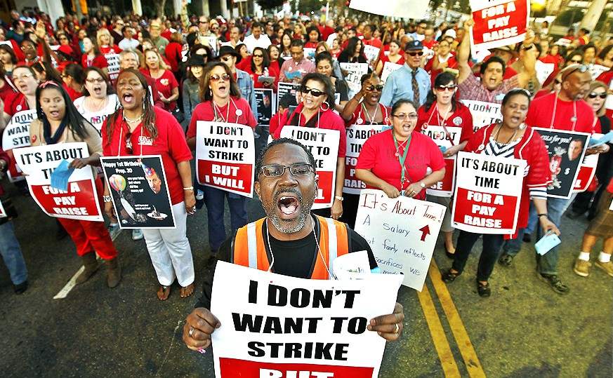 LA teachers marching carrying signs "I don't want to strike, but I will"